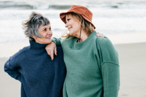 Senior women walking on the beach about Life Insurance